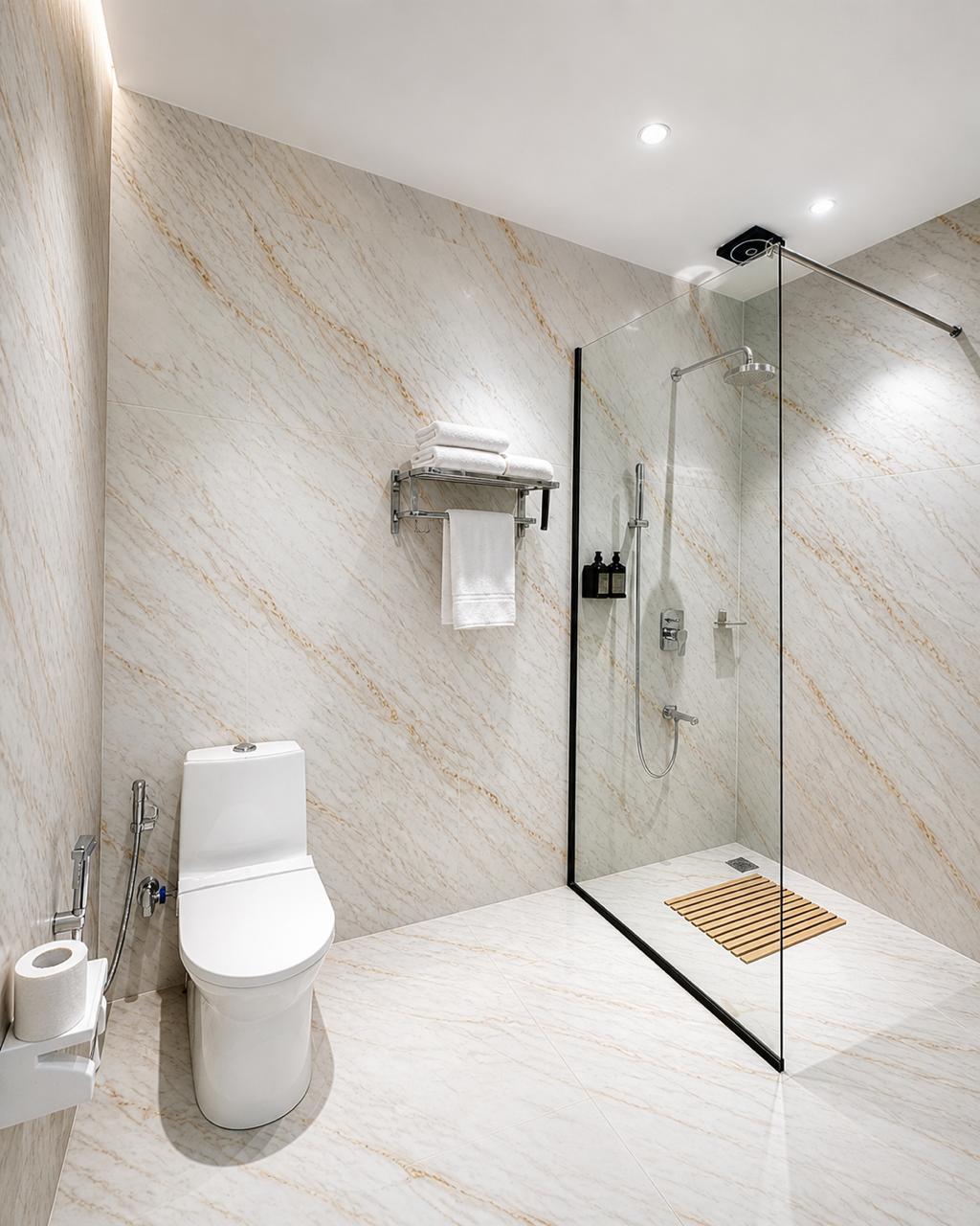 Marble bathroom shower at Tiraya — glass partition, rain shower, premium amenities